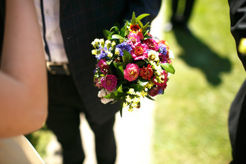 gorgeous stylish elegant groom and best man holding colorful bou