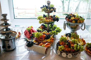 stylish luxury decorated tables with fruits for the celebration