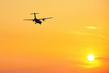 Fototapeta na wymiar Airplane at the sunset