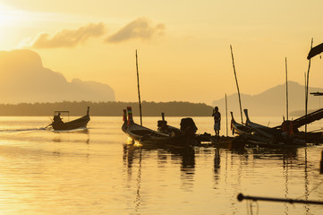 Landscape of andaman long tailed boat southern of thailand floating on sea water with sun shine