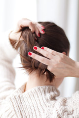 Fototapeta premium Woman making hair bun