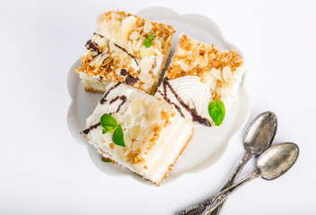 Serving cake with a creamy cream isolated on white