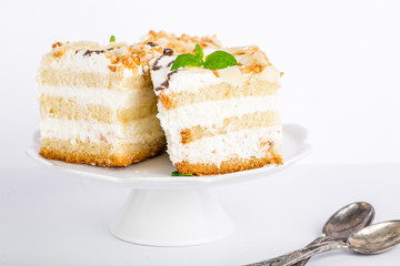 Serving cake with a creamy cream isolated on white