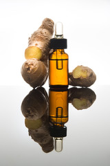 Ginger essential oil in amber bottle with ginger root and dropper - 101030501