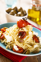 Homemade pasta with baked tomatoes and cheese