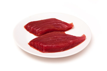 Raw Yellowfin tuna fish steaks isolated on a white background