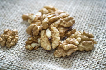 Cracked walnuts  on burlap background