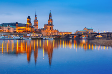 Fototapeta premium Dresden Cathedral of the Holy Trinity or Hofkirche, Bruehl's Terrace or The Balcony of Europe, Semperoper and Augustus Bridge with reflections in the river Elbe at night in Dresden, Saxony, Germany
