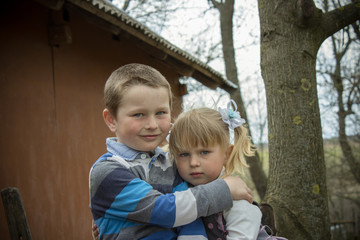 Brother sister hugging in the village