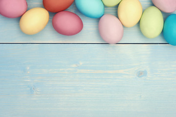 Colorful easter eggs on wooden plank