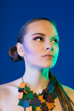 Closeup portrait of young beautiful woman with bright fashion makeup