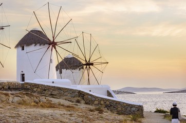     Windmills in Chora,Mykonos,Greece at sunset.Greek whitewashed architecture,a popular...