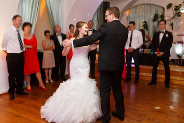 happy stylish groom and bride are dancing on the background fash