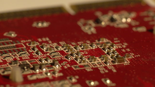 Closeup of a red computer circuit board with small details