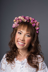 young bride looks into camera. beautiful makeup and jewelry in pink