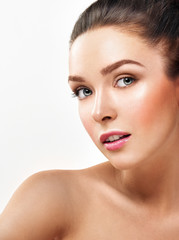 Beautiful face of young adult woman with clean fresh skin. Looki
