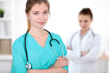 Fototapeta premium Portrait of young female surgeon doctor in a hospital