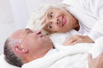 Fototapeta na wymiar Amorous senior couple in bed