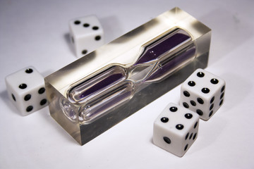 four dice and an hourglass