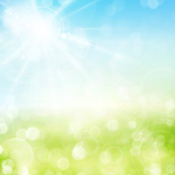 Green spring bokeh background with sunny sky and blurry light do