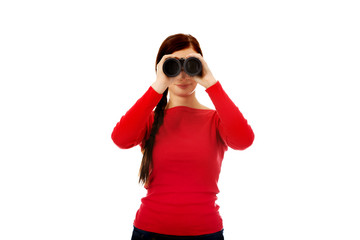 Young woman looking through a binocular