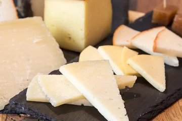 Fotobehang Table of assorted cheeses © ihorga