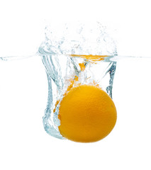 Fototapeta na wymiar orange falling or dipping in water with splash
