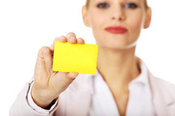 Young business woman holding small empty paper card