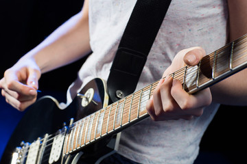 Naklejka premium musician playing electric guitar with mediator