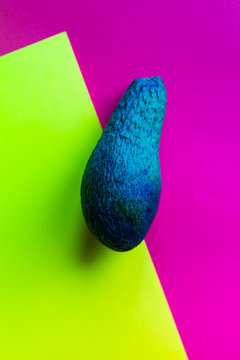 an avocado set on red and yellow background, abstract colors