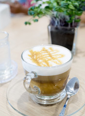 coffee cup on wooden table on brown background.