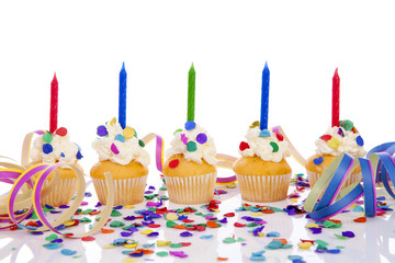 Birthday cupcakes with candle and colorful confetti