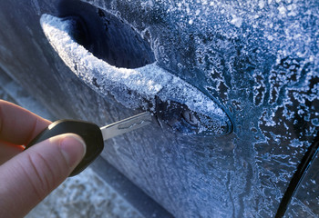 Unlocking a car door on a cold frozen winter morning