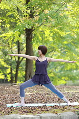 Japanese woman doing yoga warrior II pose