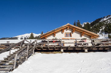 Cottage Garfiun nearby the Klosters trail in snow covered landscape, Switzerland 2015.