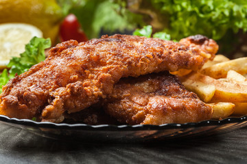 Fried fish in crispy batter with chips