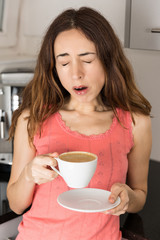 Tired woman with a cup of coffee