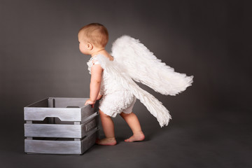 Baby angel dragging box with  winter,
