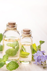 fresh mint essential oil and flowers