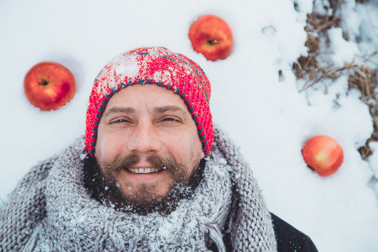  Close up portrait of a bearded man near the apple tree in the winter.

