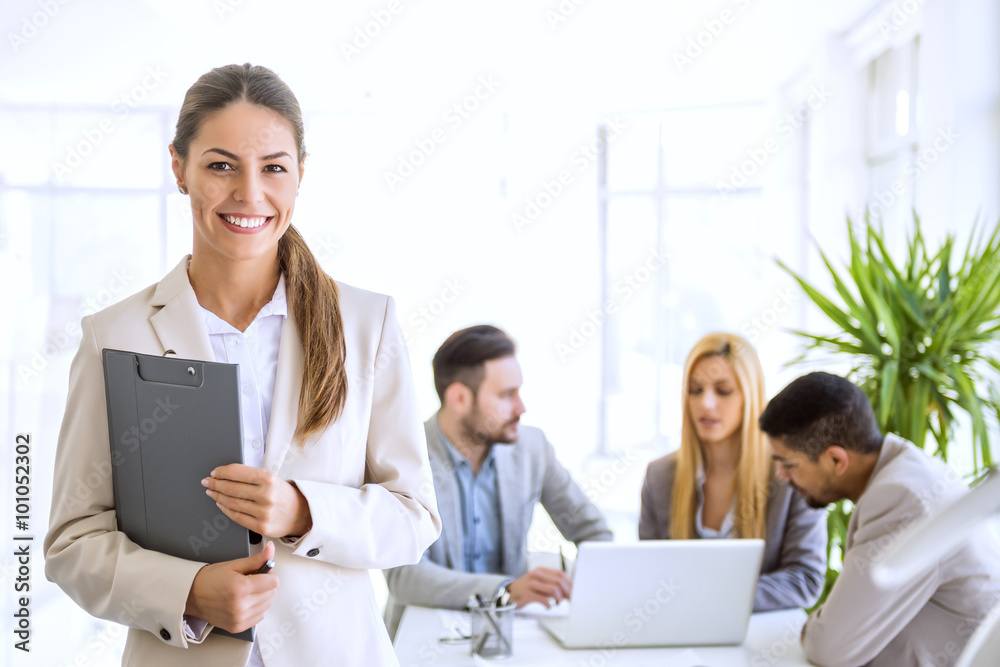 Wall mural successful businesswoman at the office leading a group