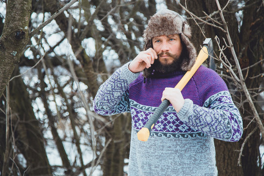 Portrait of a Bearded Man with an ax in his hand.North bearded man with an ax in the woods.
