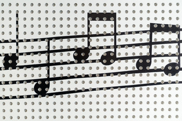 Music note on the white wall background