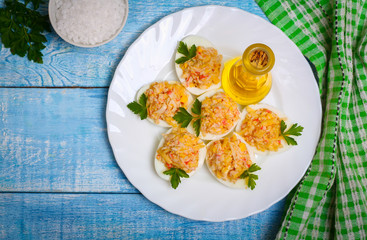 Eggs stuffed with crab and cheese on a wooden table
