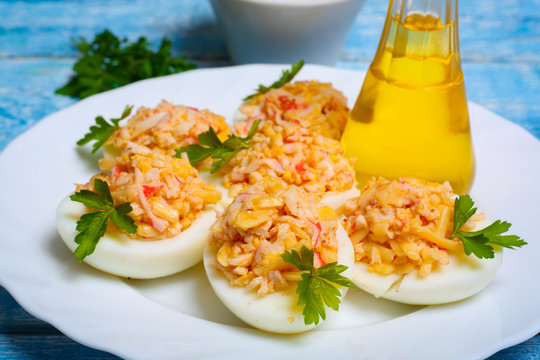 Eggs stuffed with crab and cheese on a wooden table