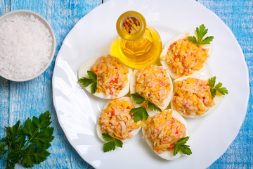 Eggs stuffed with crab and cheese on a wooden table