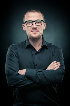 man with glasses, guy with glasses on a dark background, guy in a black shirt and glasses on a dark background