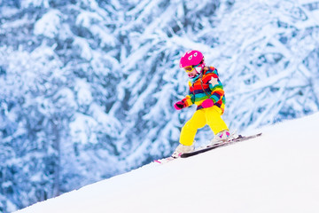 Little girl skiing in the mountains