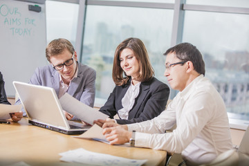 Business people working together in meeting room, a business team of three in office and planning work