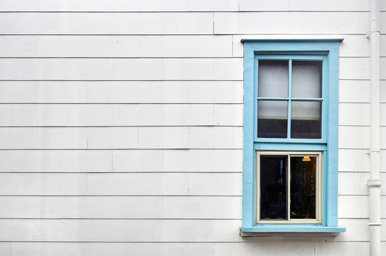Blue window on white wall